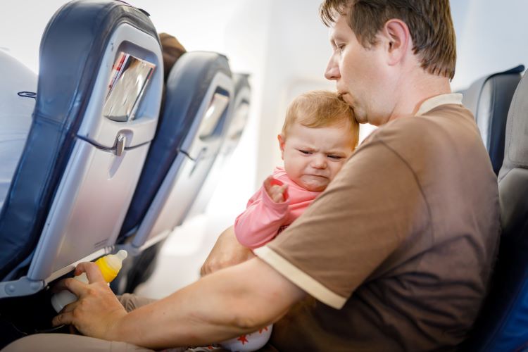 fussy baby frustrated dad on airplane