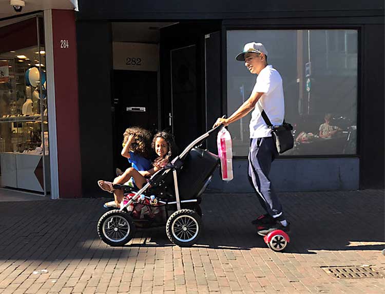 no worrying father would push kids on a double stroller while on a hoverboard