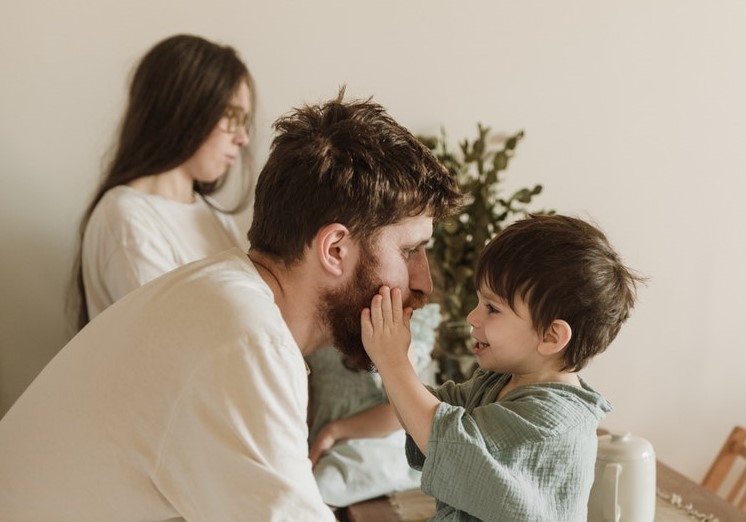 favorite parent boy touches dad face happy