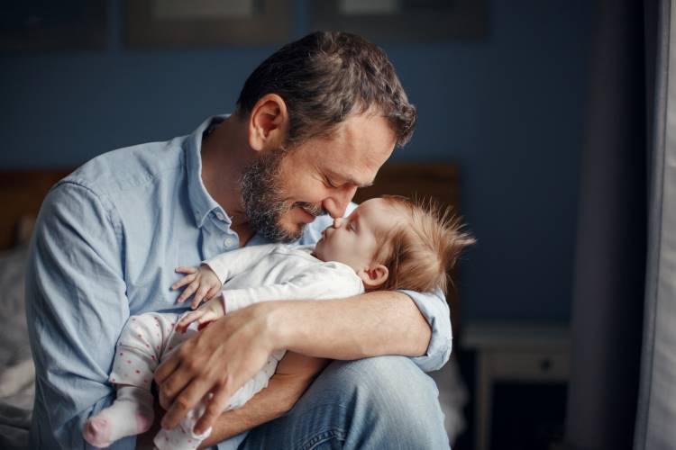 parenting concepts dad holding newborn