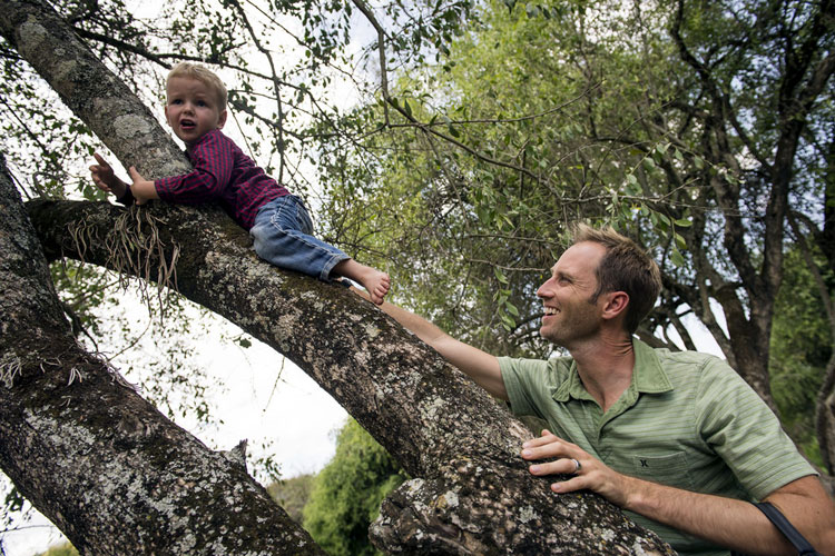 sahd climbing tree with child